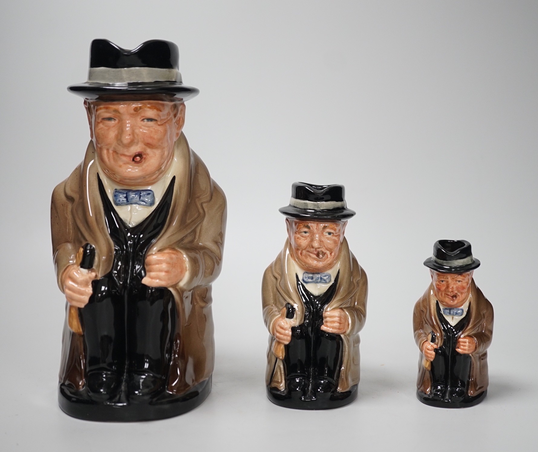 Three graduated Royal Doulton 'Churchill' character jugs, 23cm